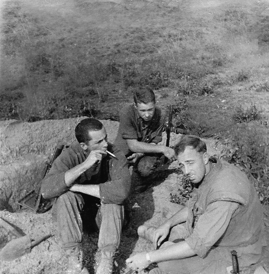 Marines taking a smoke break in a trench